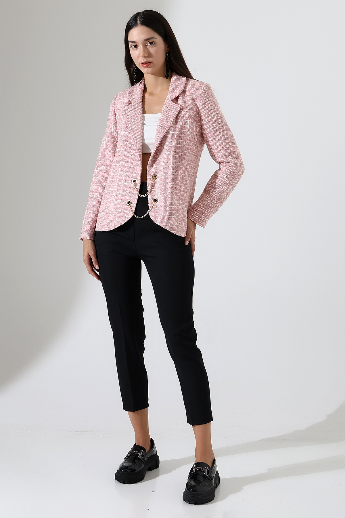 Model wearing a designer statement jacket, rose-hued woven fabric, haute couture evening wear with cream satin lining
